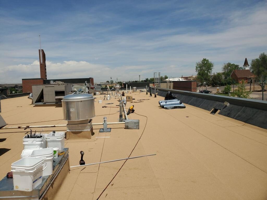 Modified bitumen commercial roof coating application with buckets and roofing tools